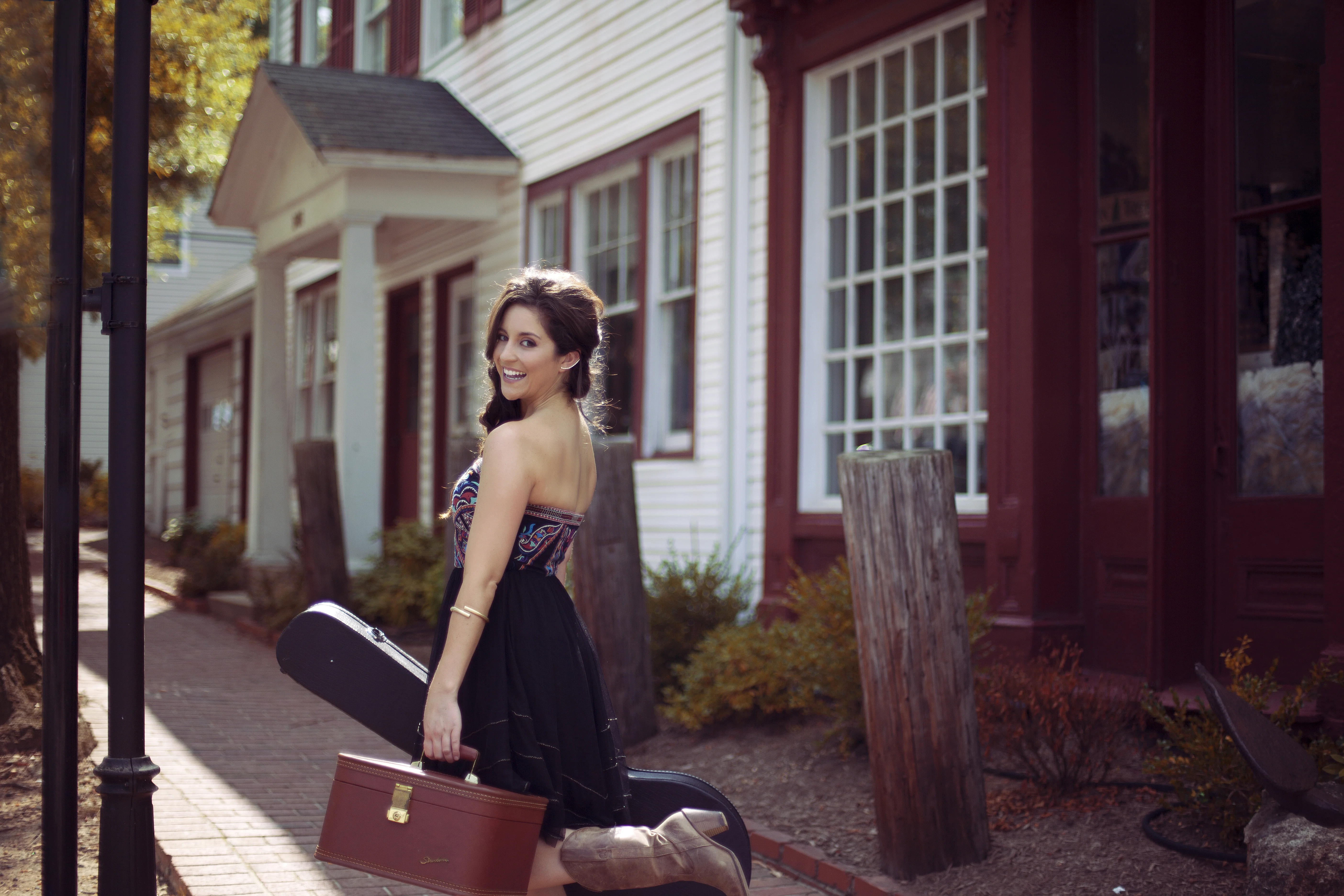 a woman sitting on a bench with luggage